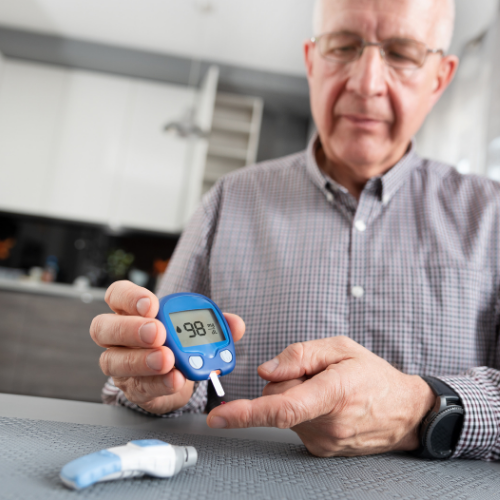 older man with diabetes checking blood sugar